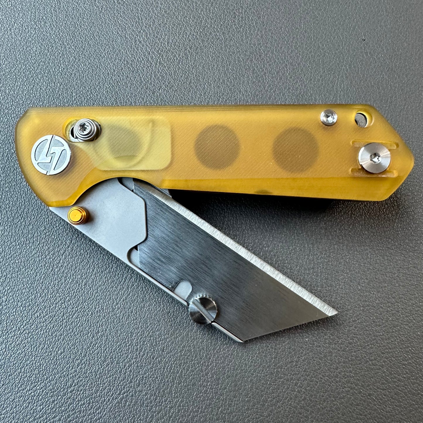 Olitans utility pocket knife cross bar lock Ultem scales